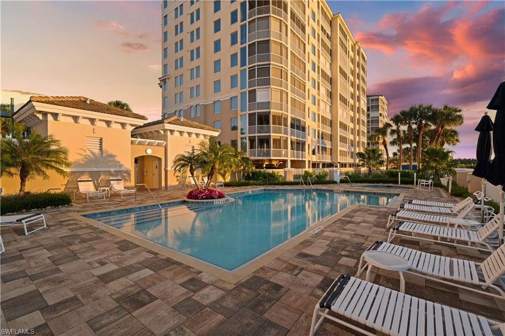 445 Dockside Drive, Unit A504 Naples, FL 34110 - Photo 6 of 50 a view of a swimming pool with a lounge chairs