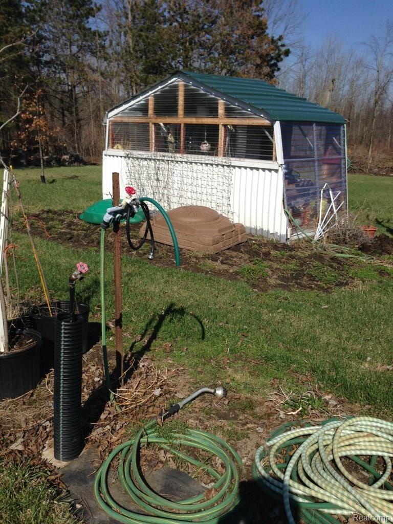 4124 North Henderson Road Davison, MI 48423 - Photo 13 of 25 Water supply by flower garden and potters shed/greenhouse