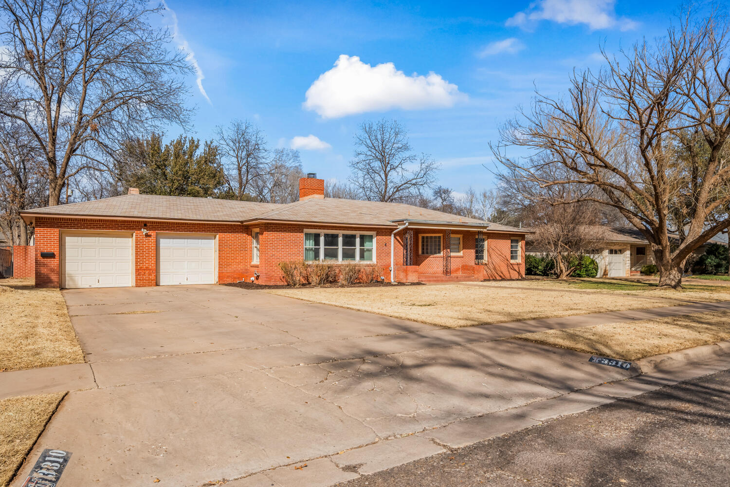 3310 24th Street Lubbock, TX 79410 - Photo 3 of 65 a front view of a house with a yard and garage