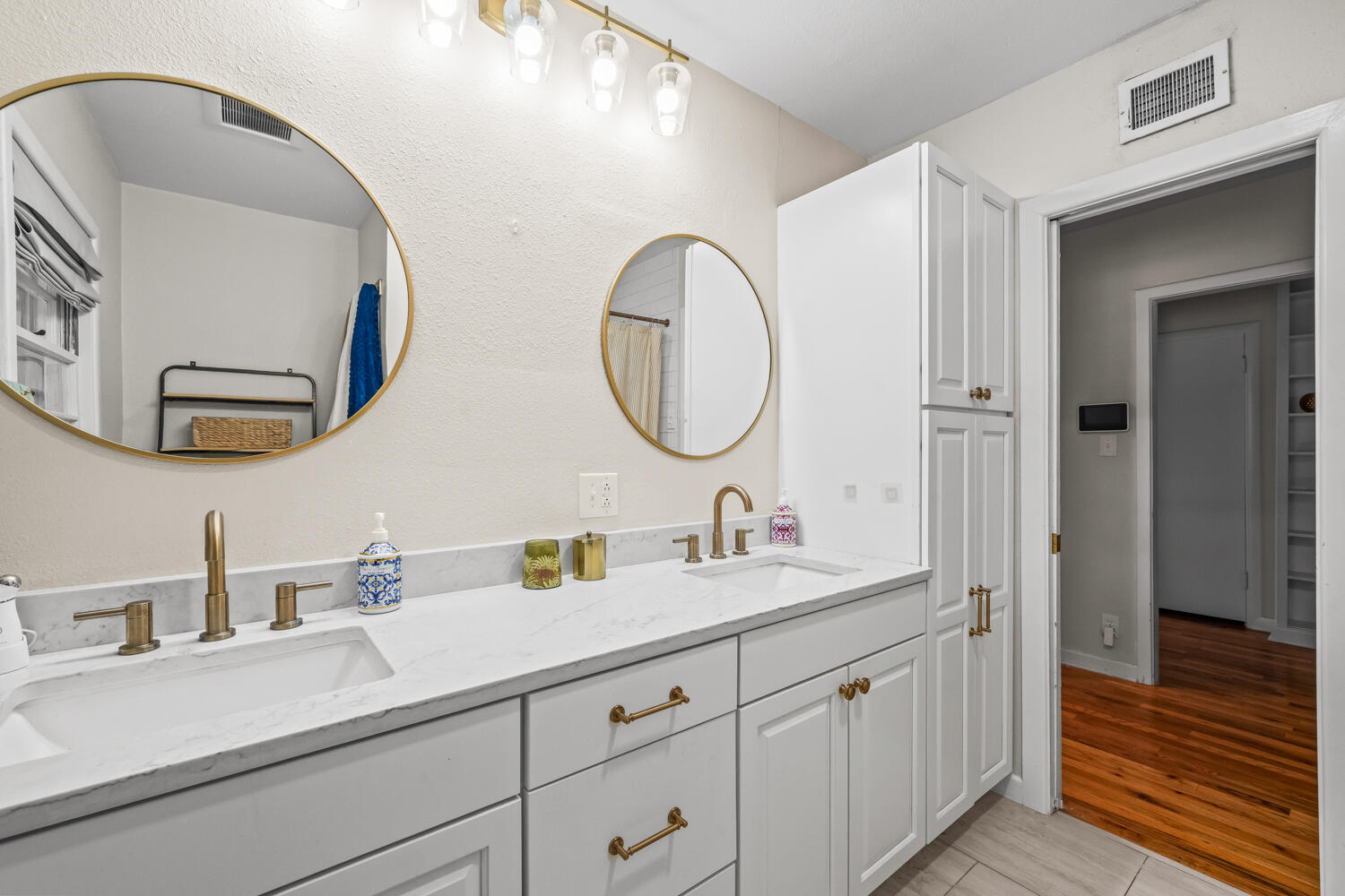 3310 24th Street Lubbock, TX 79410 - Photo 32 of 65 a bathroom with a double vanity sink and a mirror