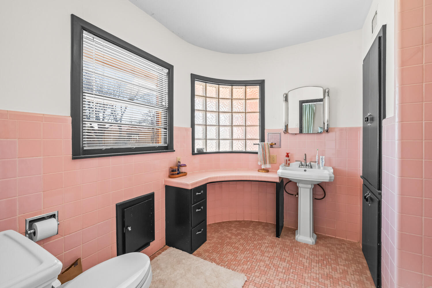 3310 24th Street Lubbock, TX 79410 - Photo 36 of 65 a bathroom with a sink toilet and mirror