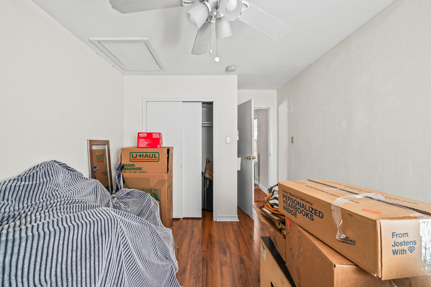 3310 24th Street Lubbock, TX 79410 - Photo 55 of 65 a bedroom with a bed and a chandelier