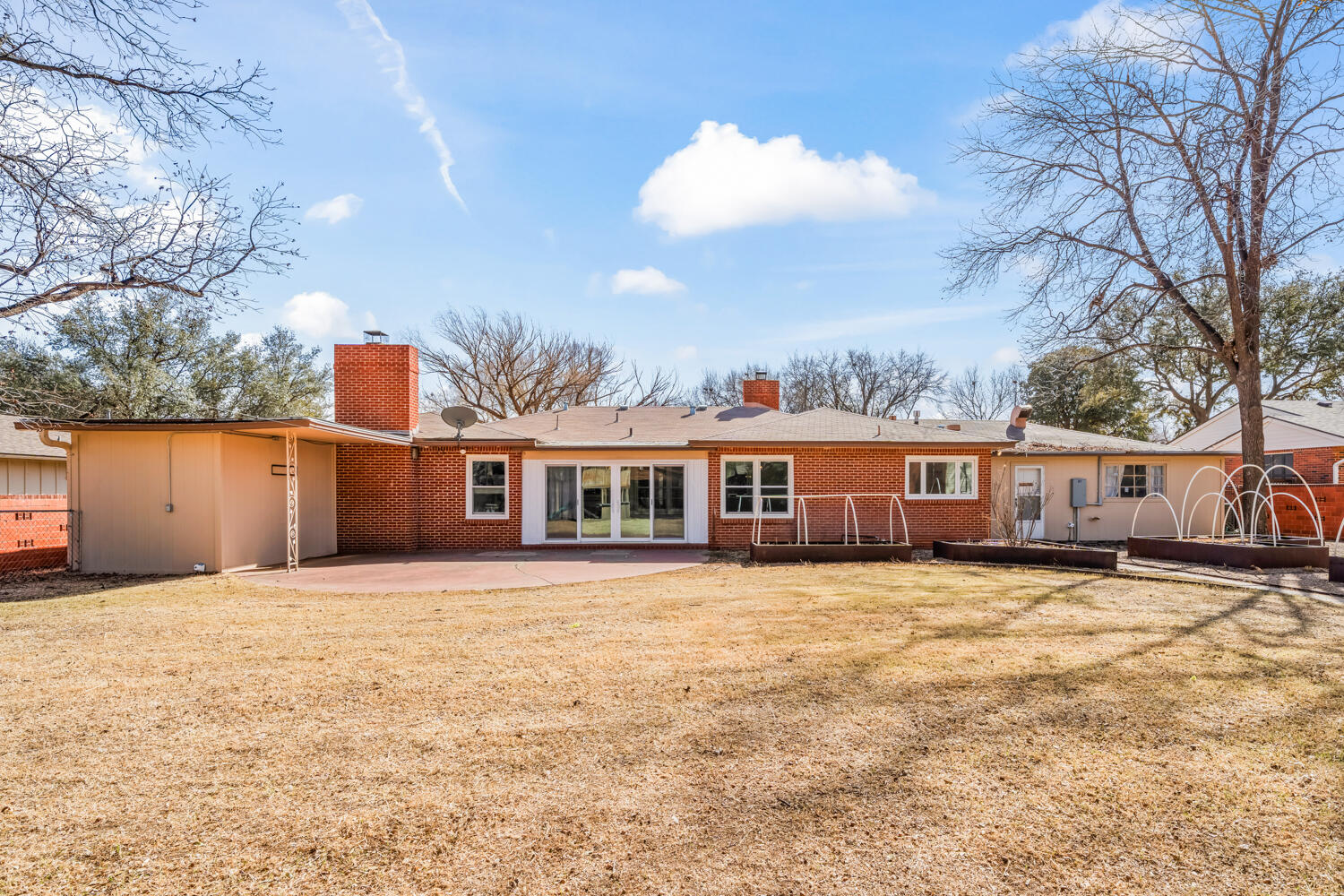 3310 24th Street Lubbock, TX 79410 - Photo 57 of 65 a front view of a house with a yard and trees
