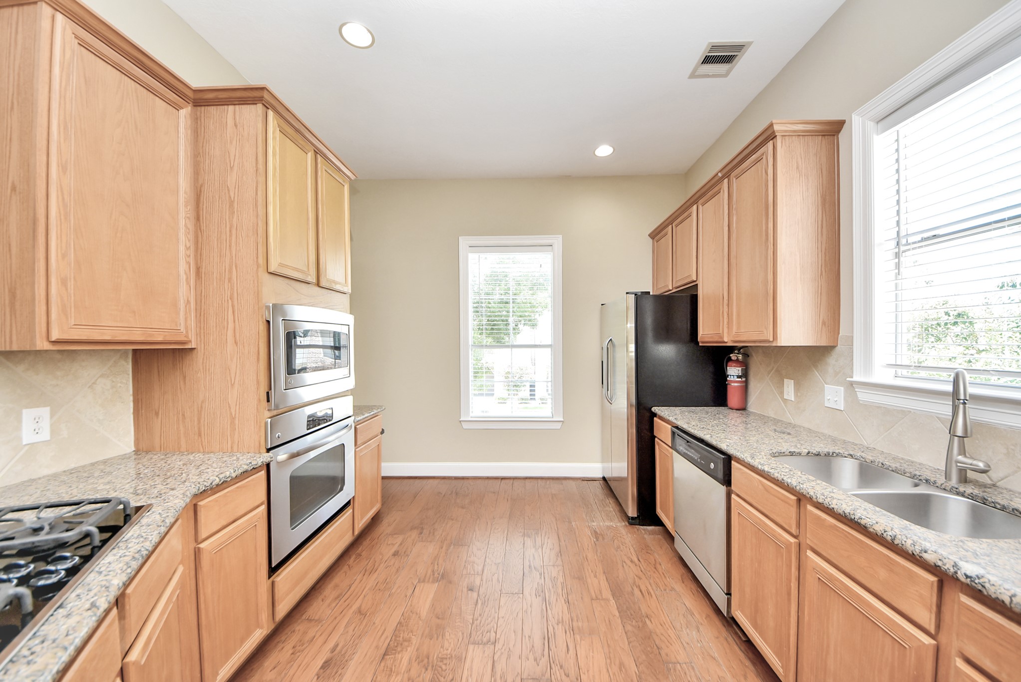 2119 Stuart Street Houston, TX 77004 - Photo 10 of 37 The kitchen has ample cabinet space for your storage needs, plus a built-in oven and microwave!