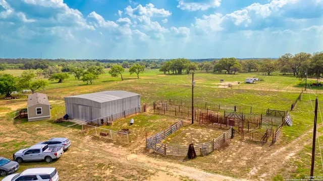 a view of a swimming pool with a lawn chairs under an umbrella