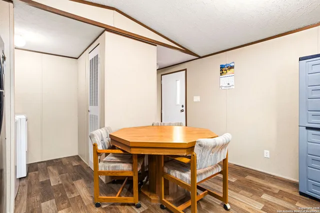 a view of a room that has a table and chairs in it