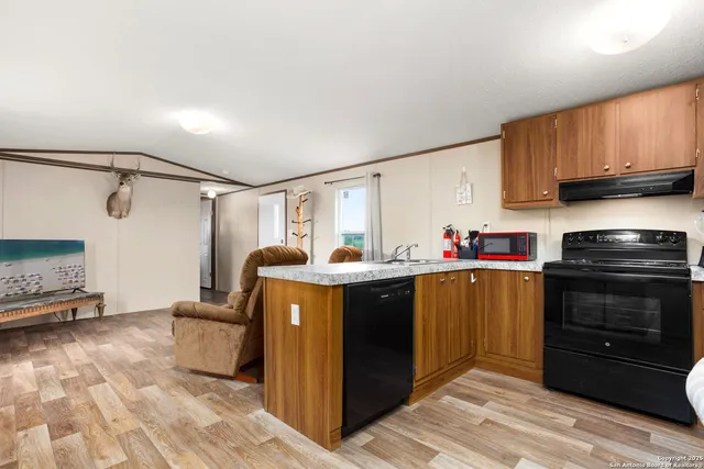 a kitchen with sink cabinets and outdoor view