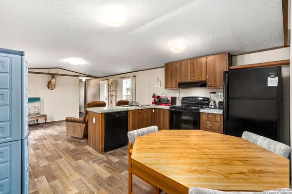 a kitchen with a refrigerator sink and cabinets