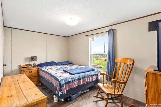 a bedroom with a bed chair and window