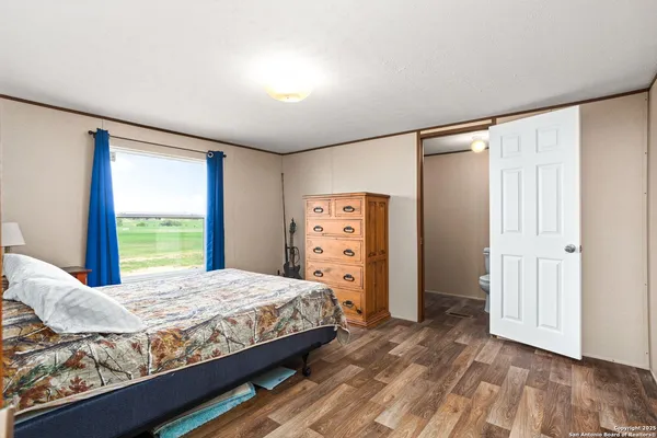 a bedroom with a large bed and a window