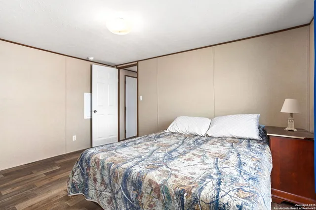 a bedroom with a bed and a lamp with the wall