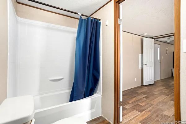 a view of bathroom with a tub and shower