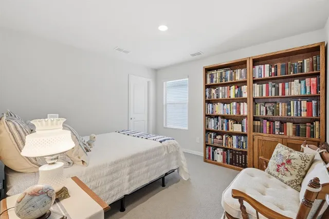 a bedroom with a bed and a book shelf