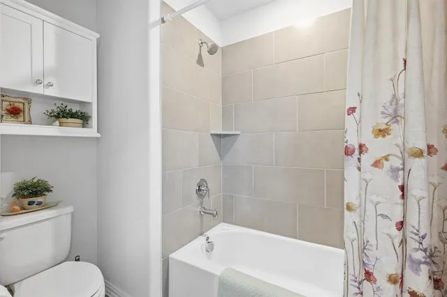 a white bath tub sitting next to a white toilet