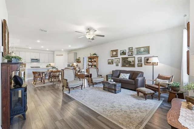 a living room with furniture kitchen view and a table