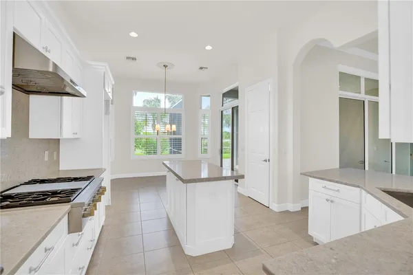 a kitchen with stainless steel appliances granite countertop a stove and a refrigerator