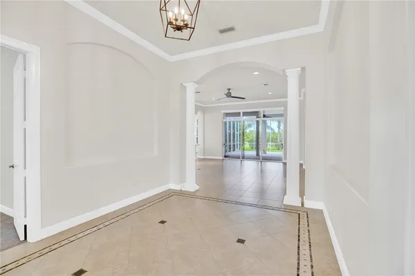 an empty room with windows and entrance