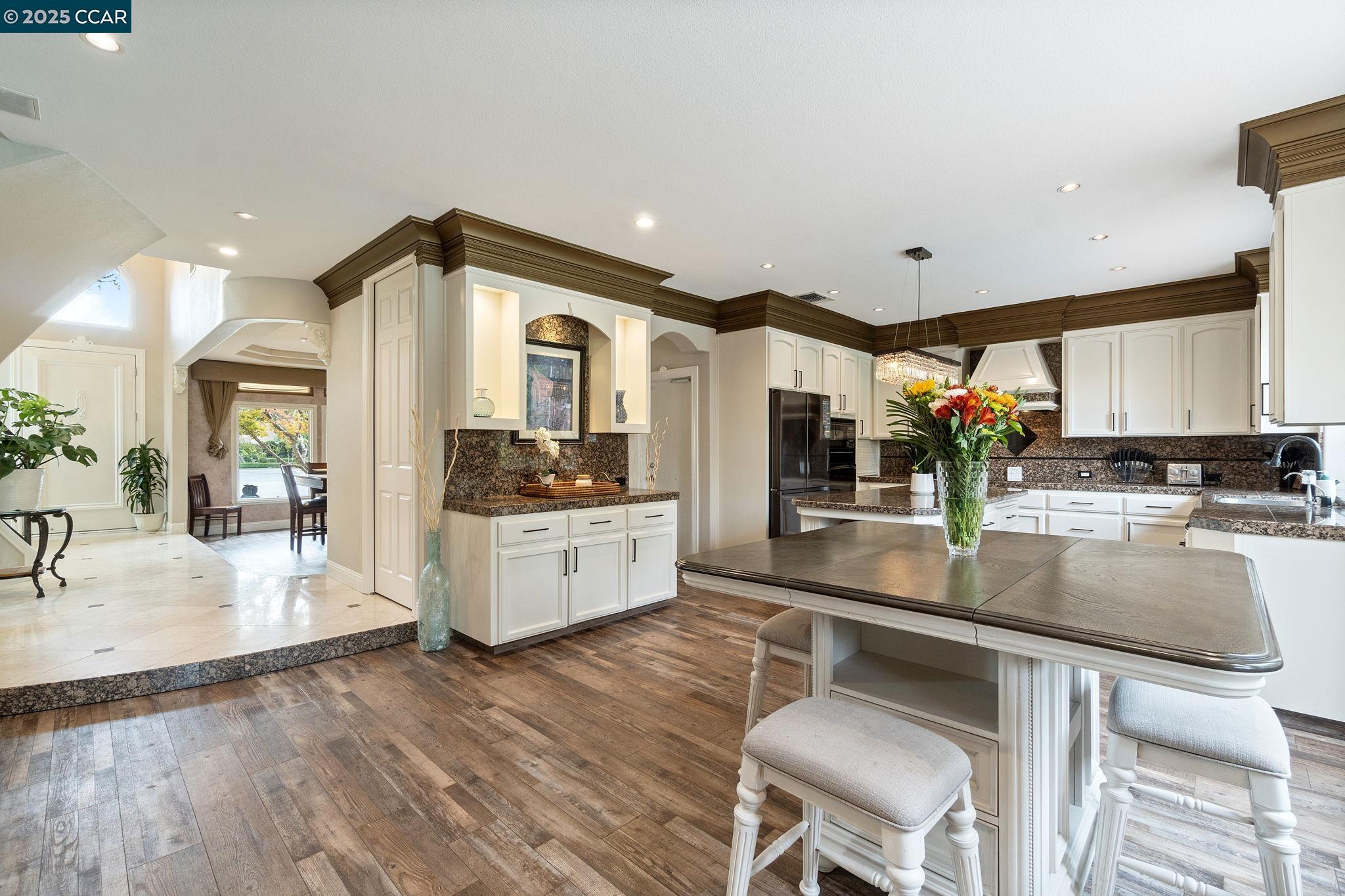 2550 East Jenny Avenue Fresno, CA 93720 - Photo 14 of 49 a kitchen with a table chairs sink and cabinets