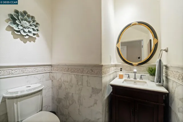 a bathroom with a sink mirror and toilet