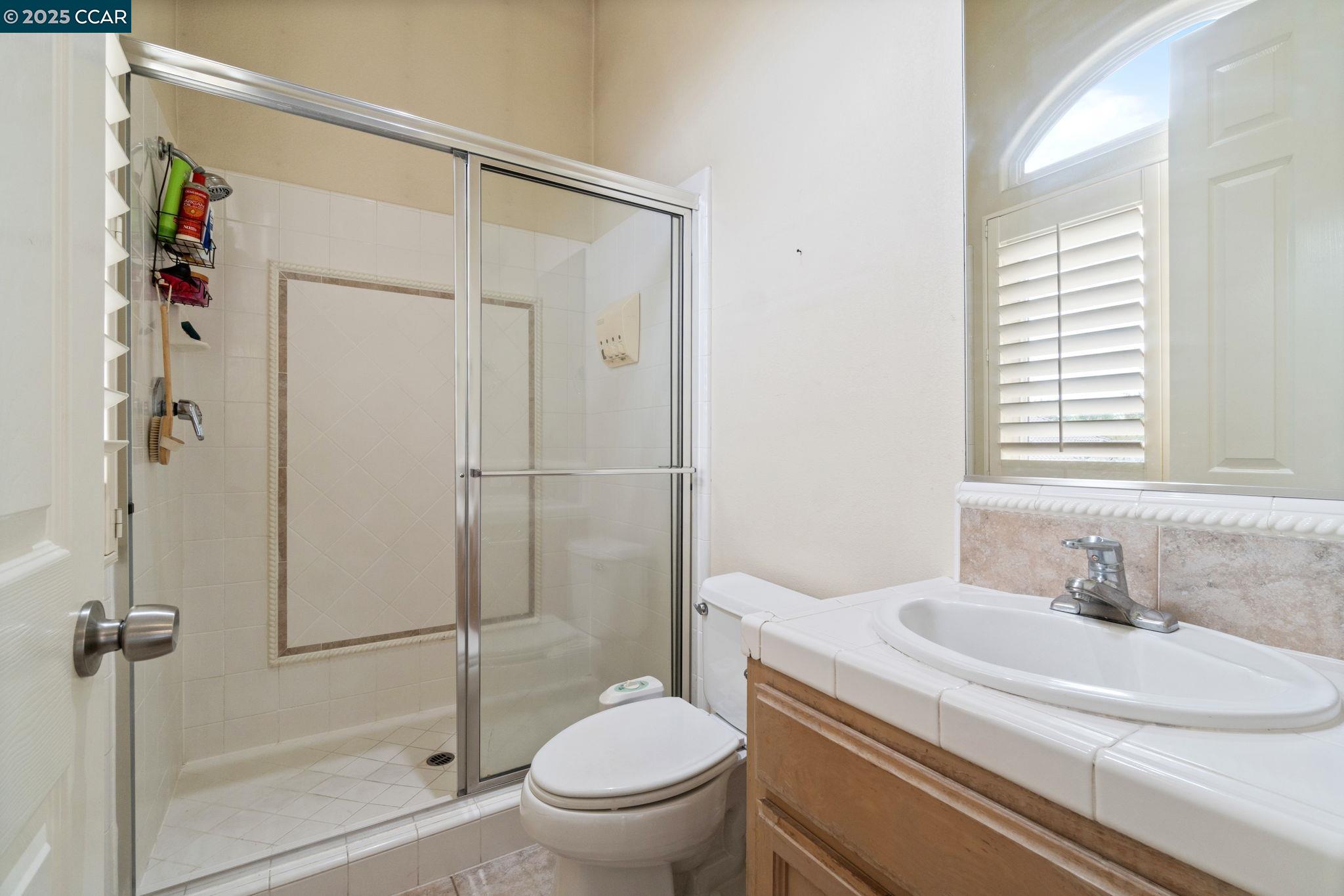 2550 East Jenny Avenue Fresno, CA 93720 - Photo 31 of 49 a bathroom with a sink toilet and shower