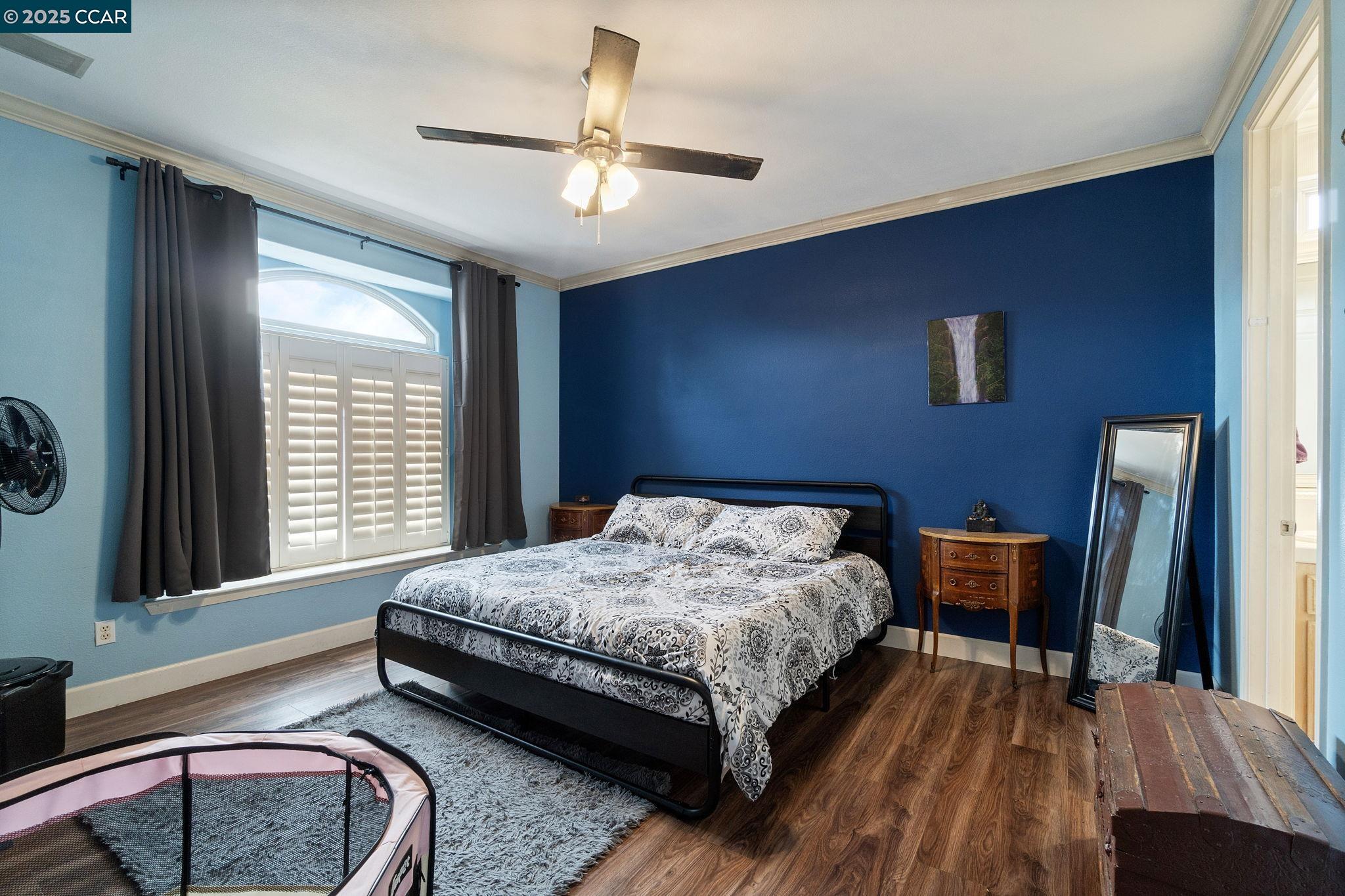 2550 East Jenny Avenue Fresno, CA 93720 - Photo 33 of 49 a bedroom with a bed and wooden floor