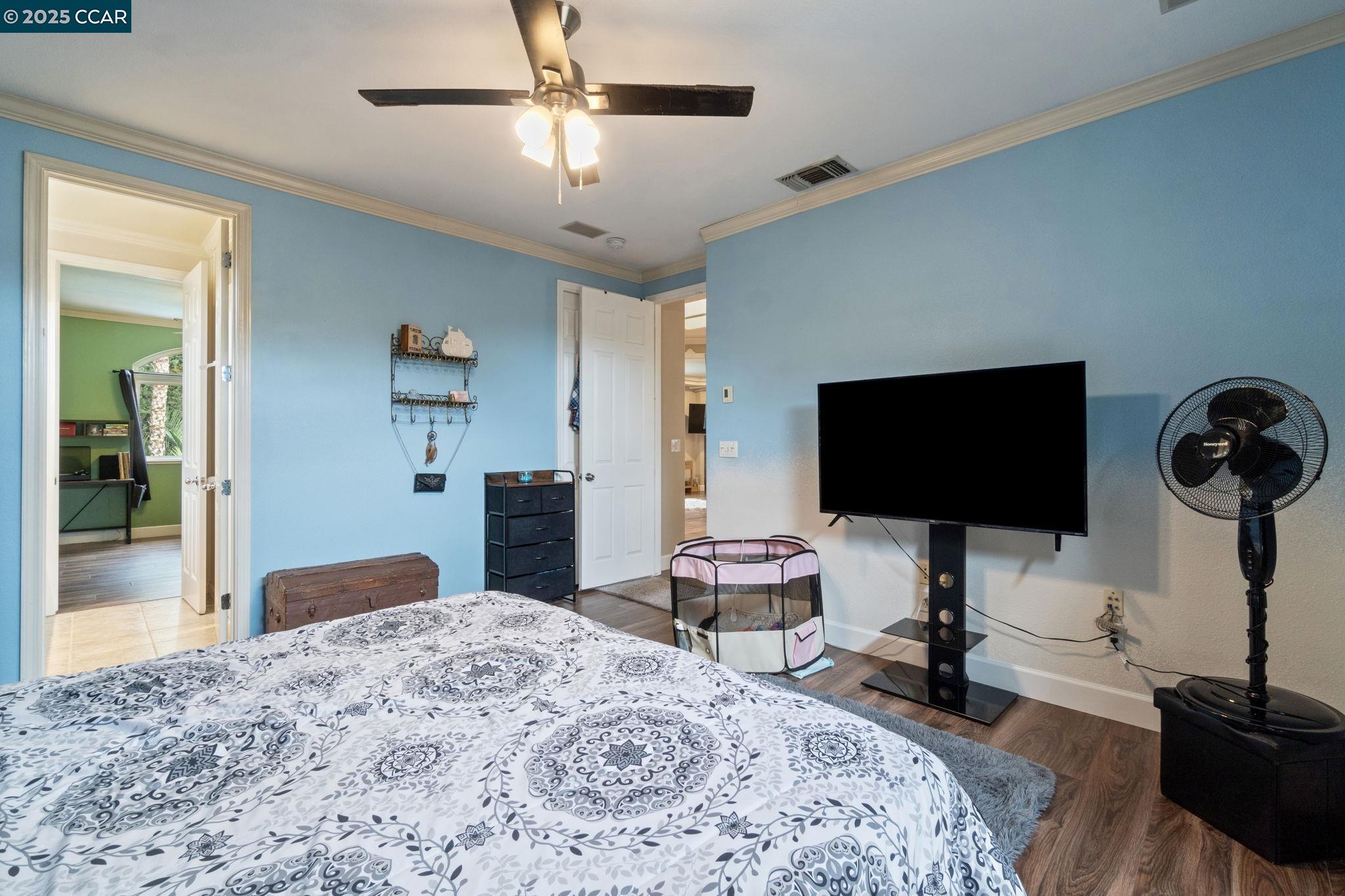 2550 East Jenny Avenue Fresno, CA 93720 - Photo 34 of 49 a bedroom with a bed and a flat screen tv