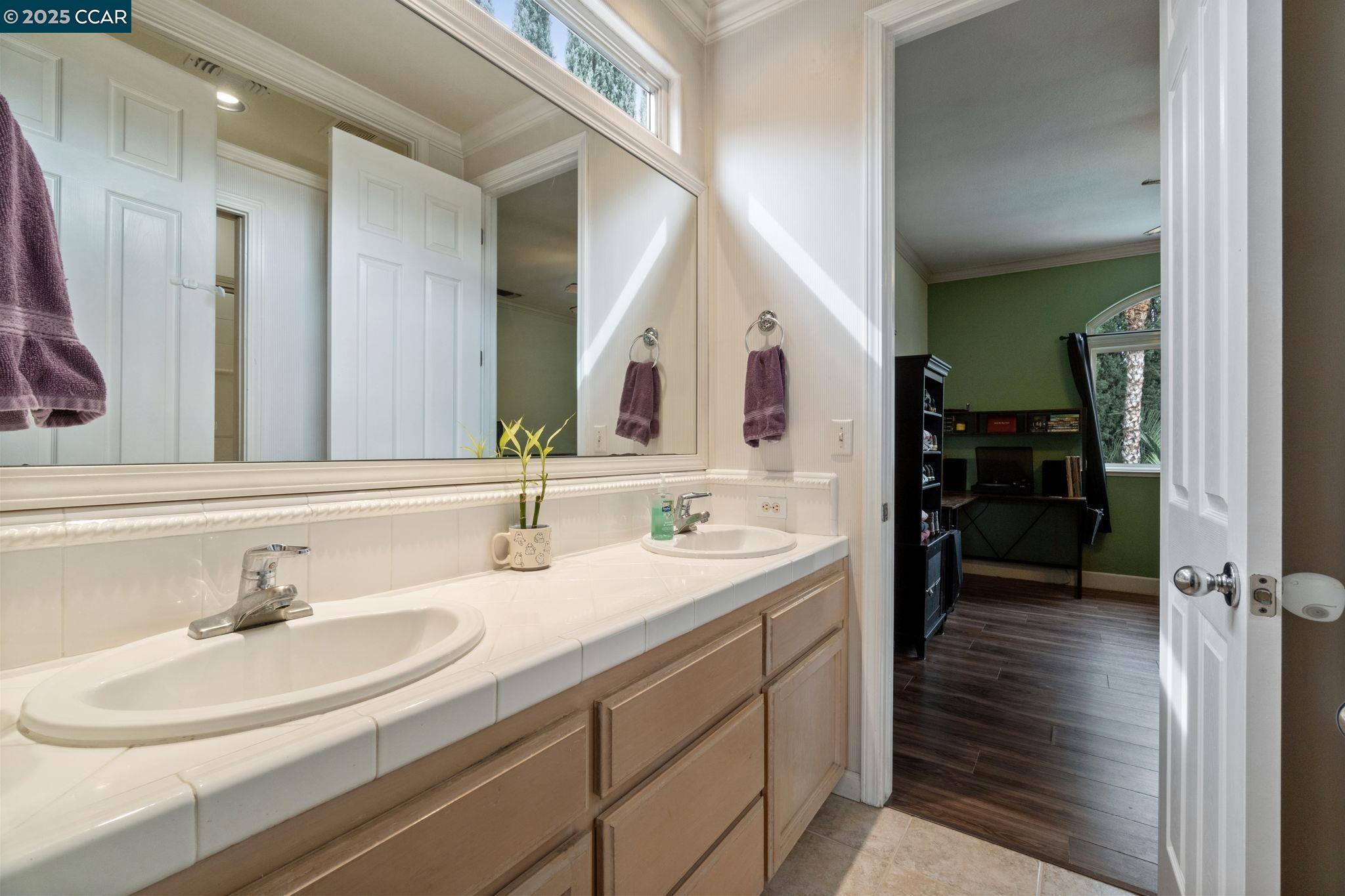2550 East Jenny Avenue Fresno, CA 93720 - Photo 36 of 49 a en suite bathroom with a sink double vanity and a mirror