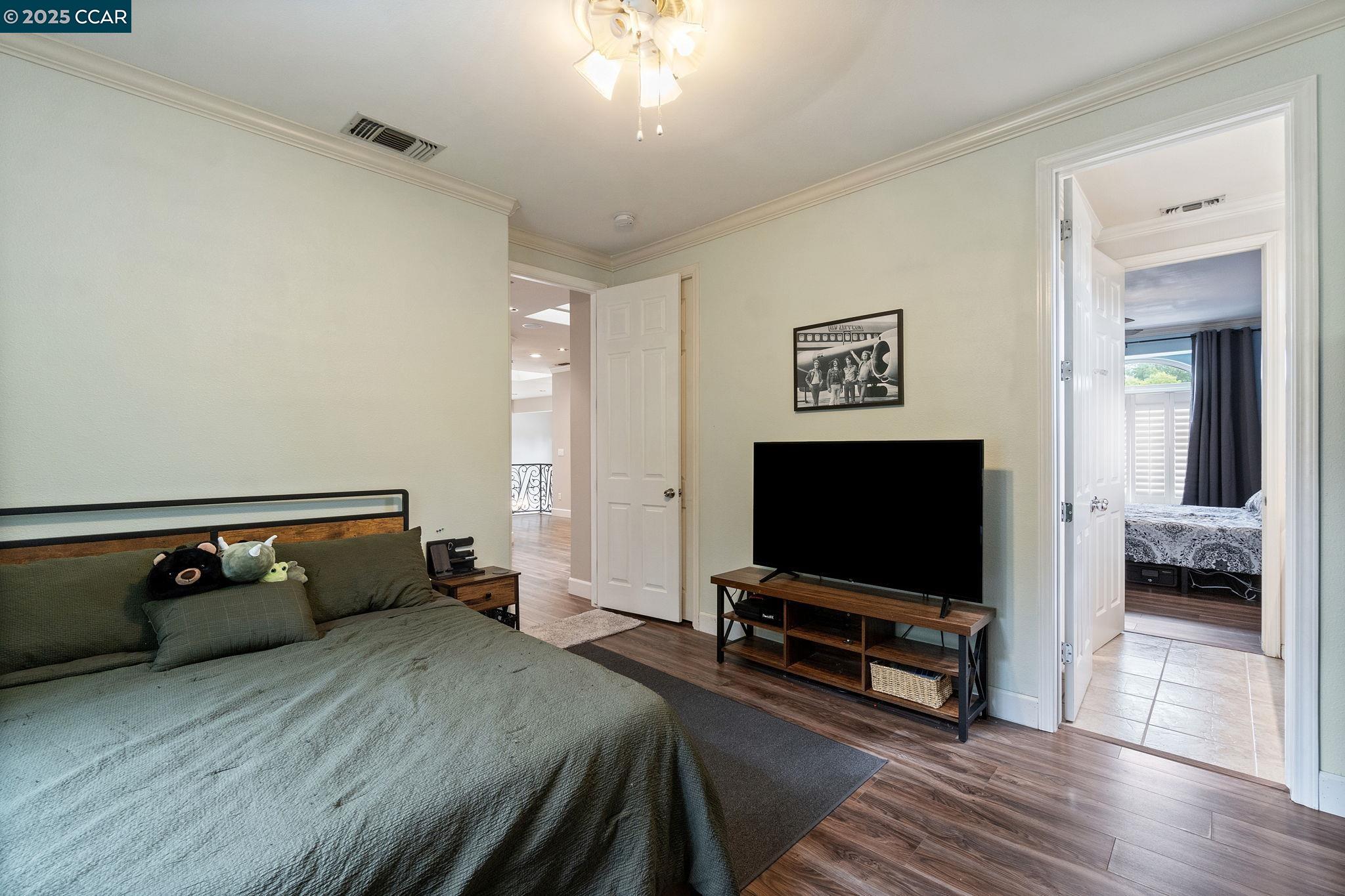 2550 East Jenny Avenue Fresno, CA 93720 - Photo 38 of 49 a bedroom with furniture and flat screen tv