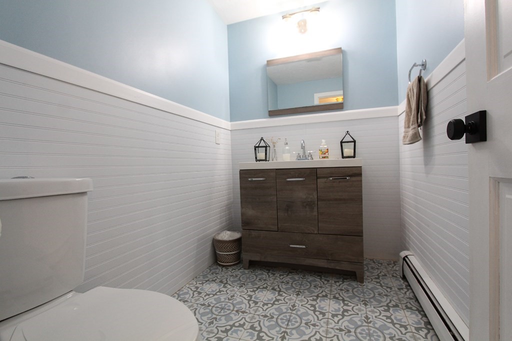47 Foxglove Road Barnstable, MA 02632 - Photo 16 of 33 a bathroom with a toilet a sink and mirror