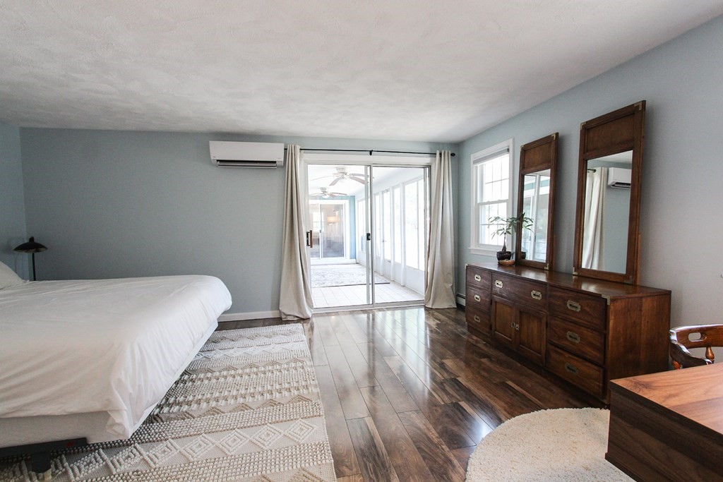 47 Foxglove Road Barnstable, MA 02632 - Photo 22 of 33 a large bedroom with a bed and wooden floor