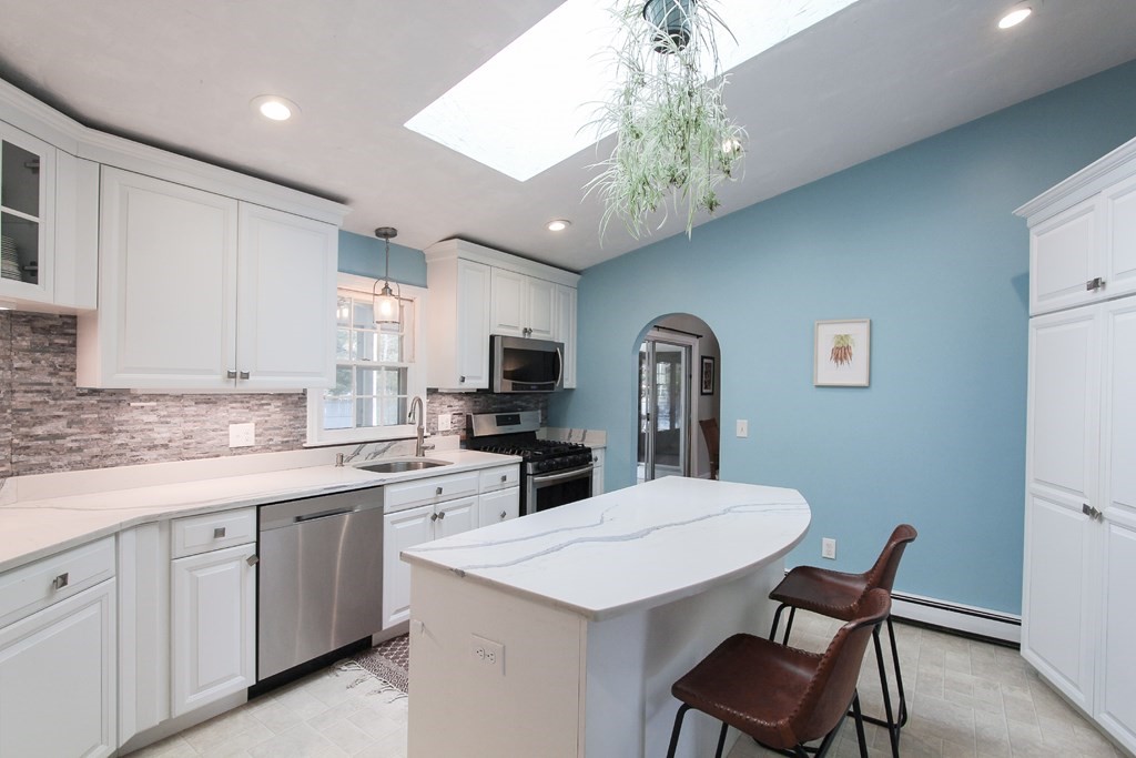 47 Foxglove Road Barnstable, MA 02632 - Photo 6 of 33 a kitchen with a table chairs sink and cabinets
