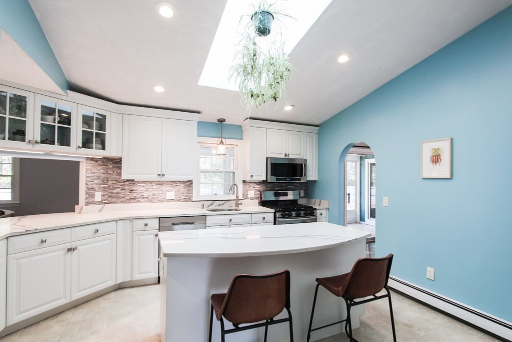 47 Foxglove Road Barnstable, MA 02632 - Photo 7 of 33 a kitchen with stainless steel appliances a sink stove and microwave