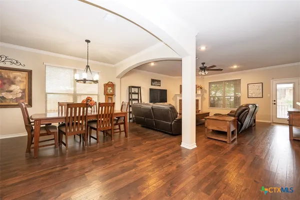 a view of a livingroom with furniture window and wooden floor