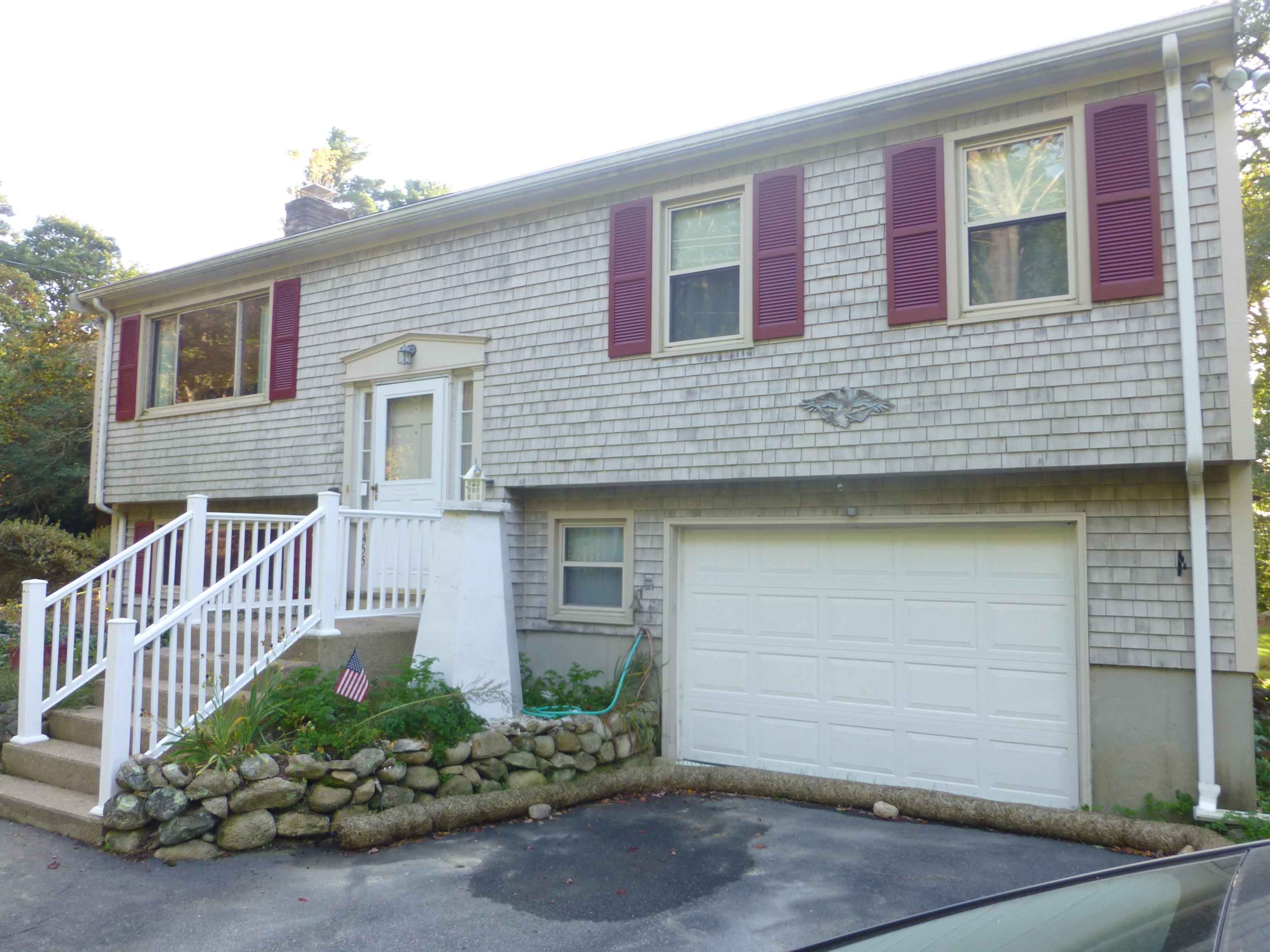 455 Huckins Neck Road Centerville, MA 02632 - Photo 3 of 32 a front view of a house with a garden