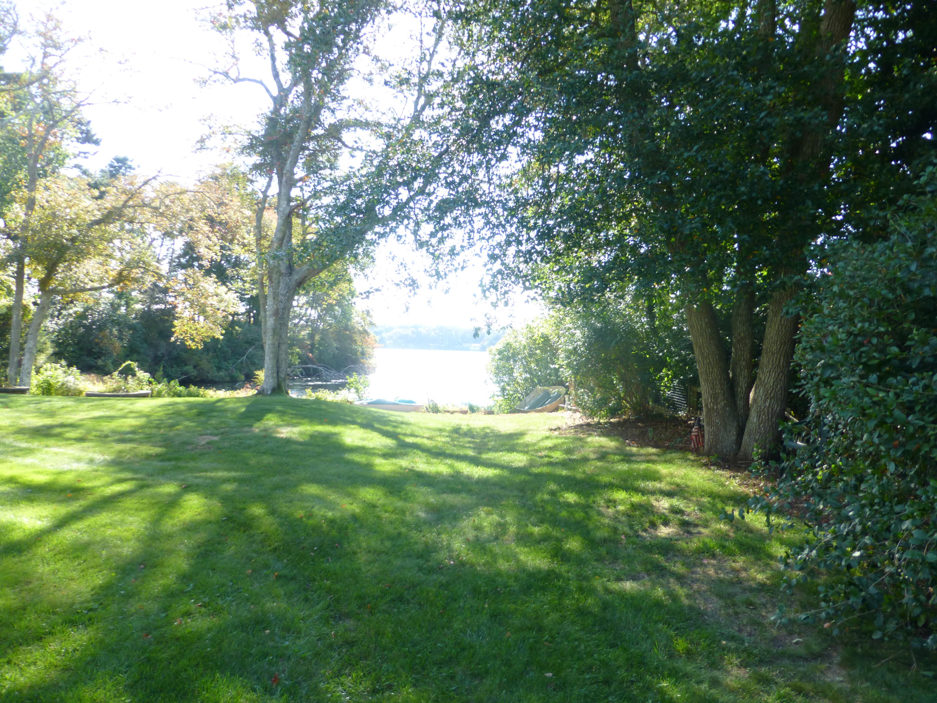 455 Huckins Neck Road Centerville, MA 02632 - Photo 8 of 32 a view of a backyard with large trees