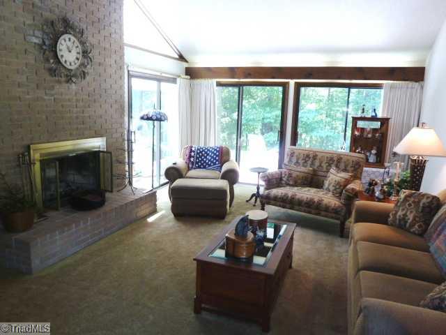 1195 Daisy Trail Road Germanton, NC 27019 - Photo 3 of 16 Den/Family/Great Room. Den area with brick fireplace and gas logs. Sliding glass doors lead to the sunroom and a large private patio area