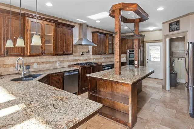 a kitchen with stainless steel appliances granite countertop a refrigerator and a stove