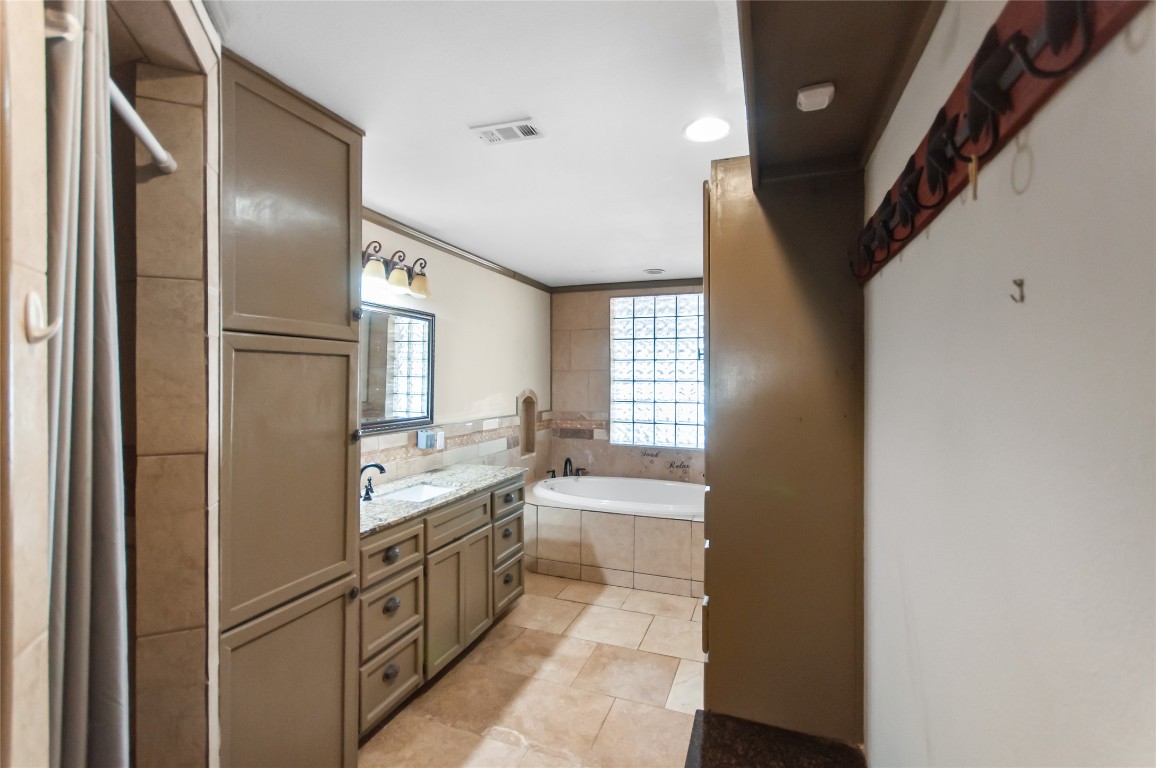 6588 Starks Road Mason, TX 76856 - Photo 19 of 40 a kitchen with granite countertop stainless steel appliances a sink and a refrigerator