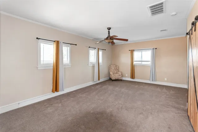 a living room with furniture stove and wooden floor