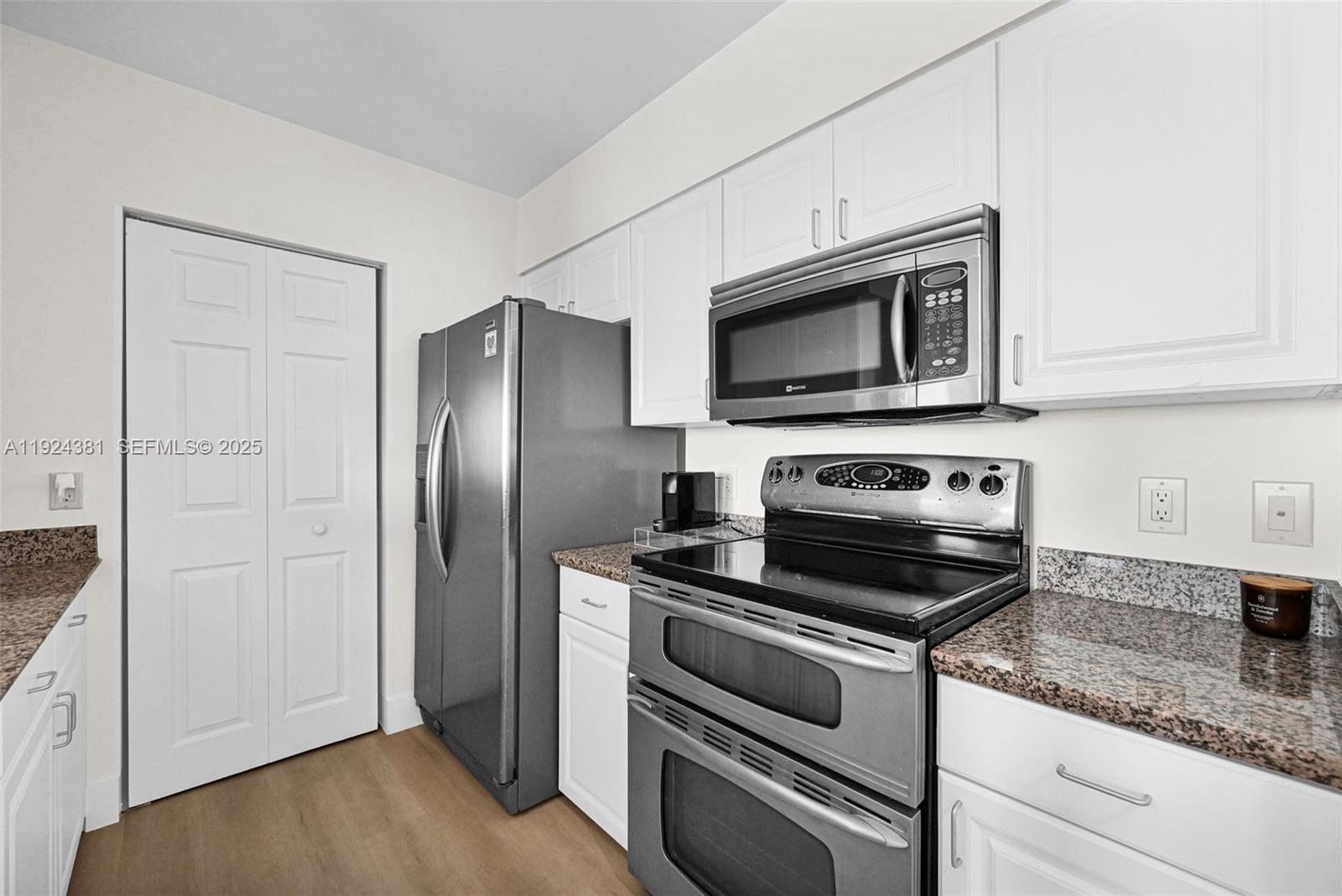 90 Alton Road, Unit 1908 Miami Beach, FL 33139 - Photo 11 of 57 a kitchen with granite countertop cabinets and steel stainless steel appliances