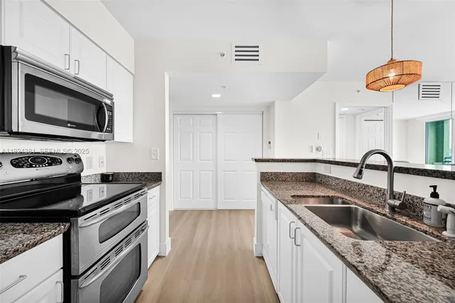 a kitchen with a refrigerator stove and microwave