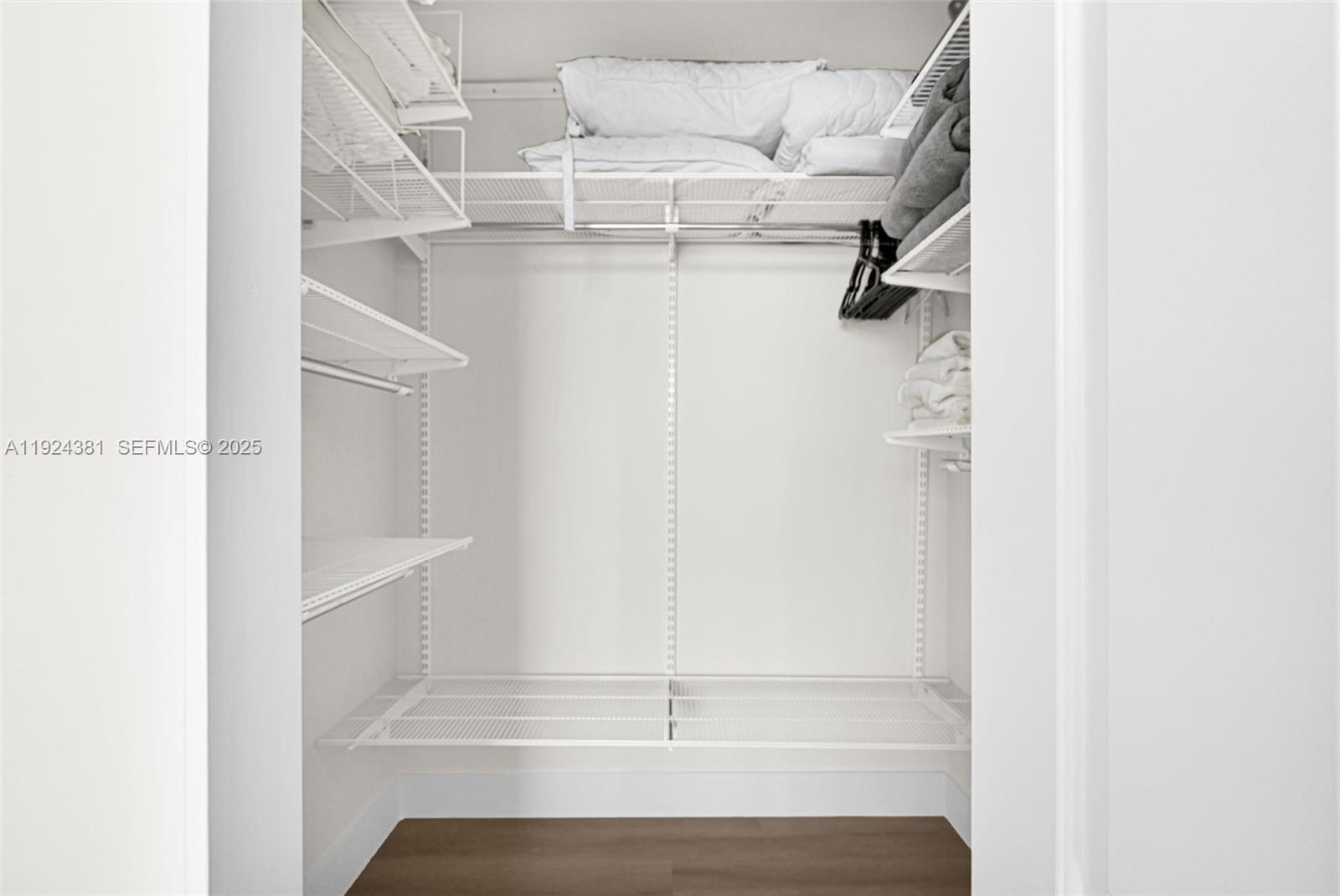 90 Alton Road, Unit 1908 Miami Beach, FL 33139 - Photo 23 of 57 a view of walk in closet with empty racks