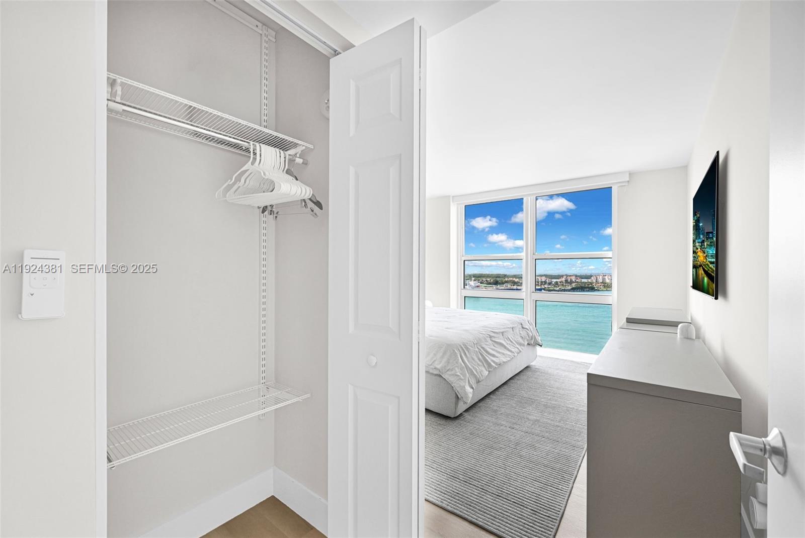 90 Alton Road, Unit 1908 Miami Beach, FL 33139 - Photo 24 of 57 a living room with furniture and a window