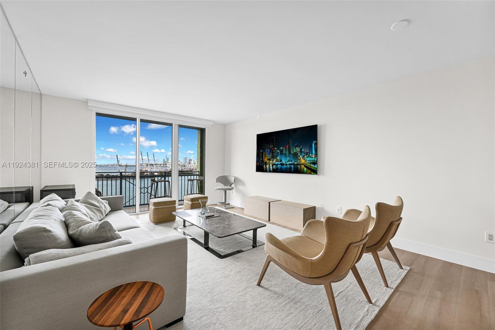 90 Alton Road, Unit 1908 Miami Beach, FL 33139 - Photo 3 of 57 a living room with furniture and a flat screen tv