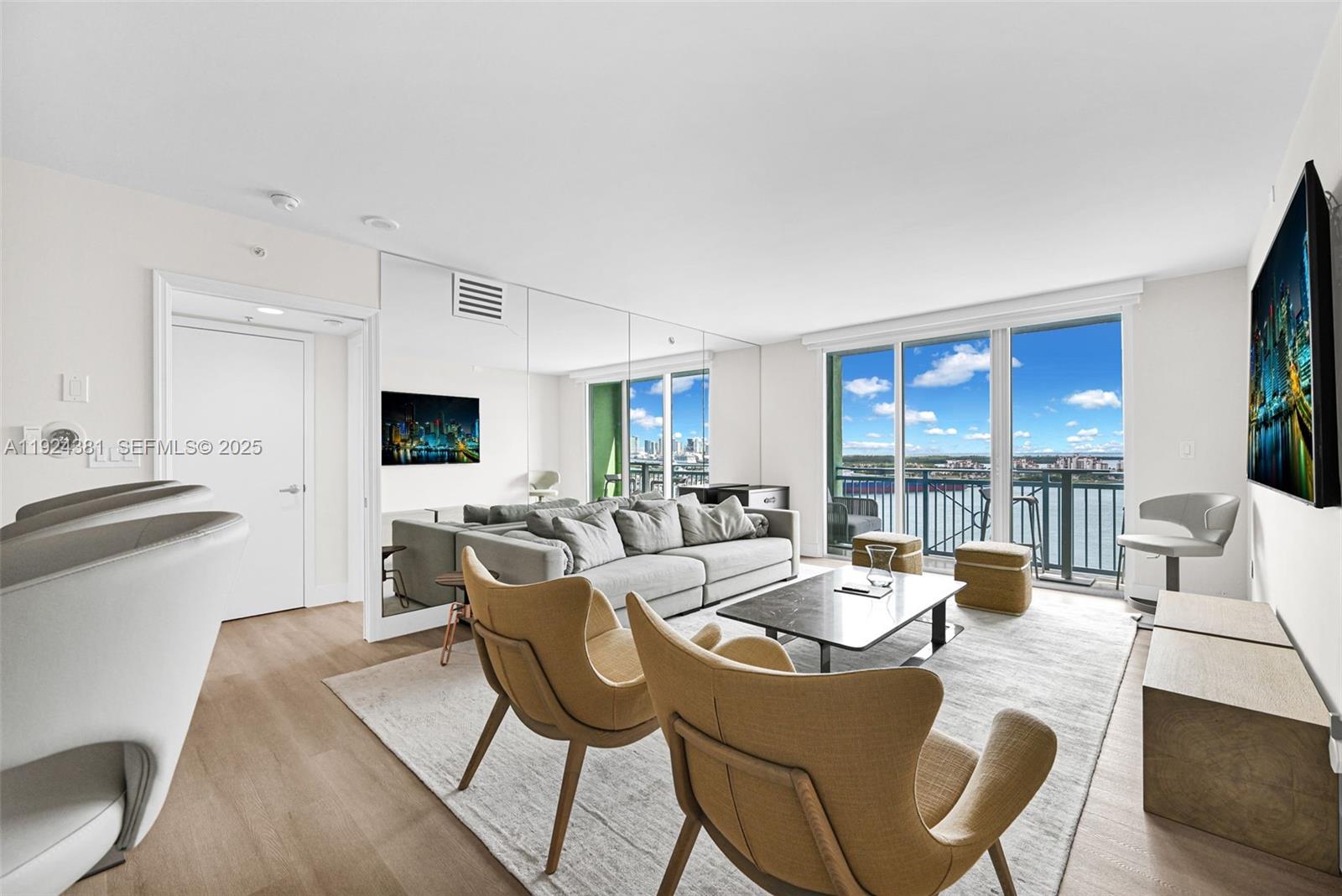 90 Alton Road, Unit 1908 Miami Beach, FL 33139 - Photo 5 of 57 a living room with furniture kitchen view and a large window