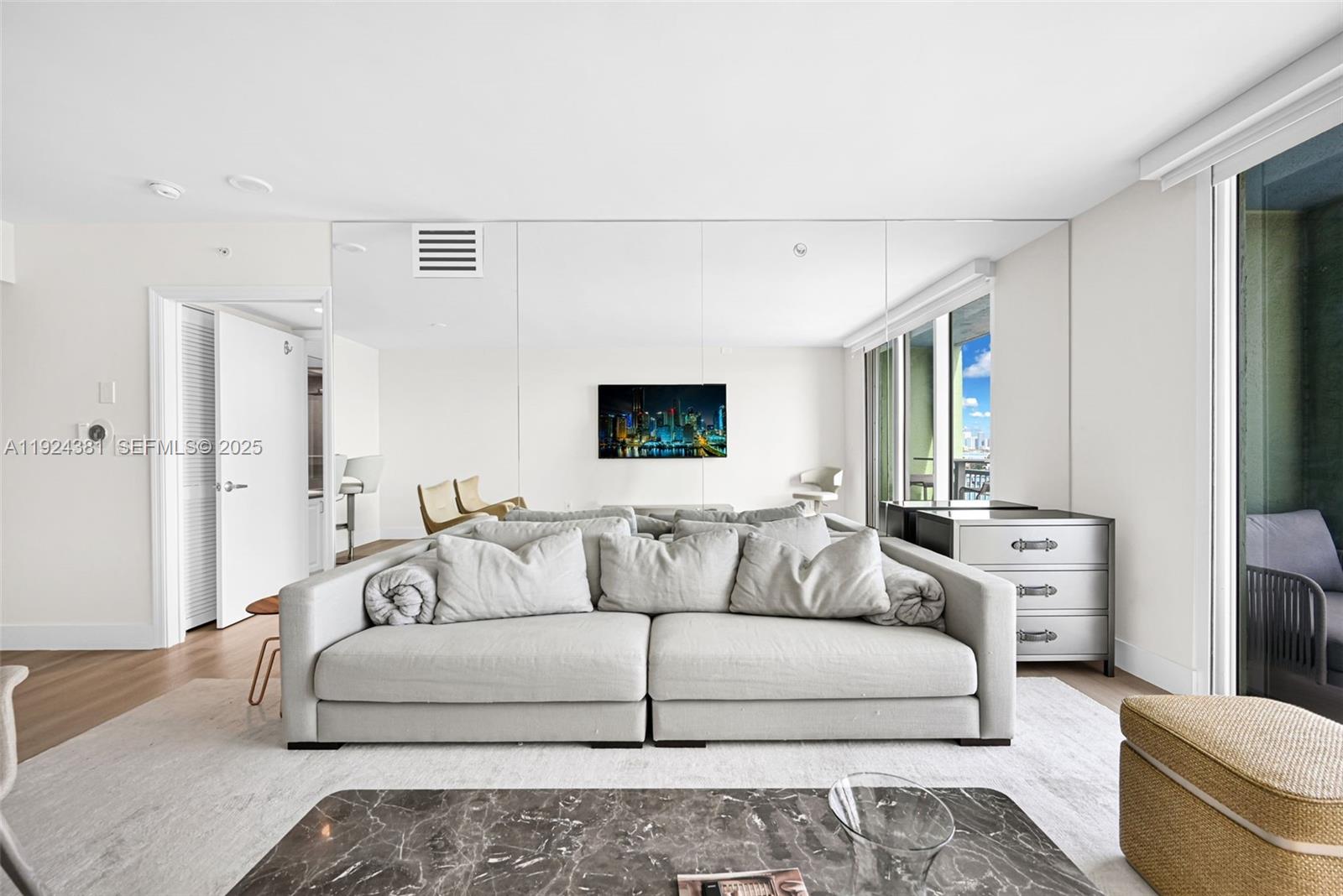 90 Alton Road, Unit 1908 Miami Beach, FL 33139 - Photo 6 of 57 a living room with furniture and a couch