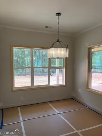 a view of an empty room with windows