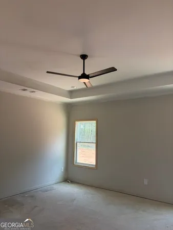 a room with a ceiling fan and a window