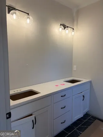 a room with cabinets and a potted plant on the wall