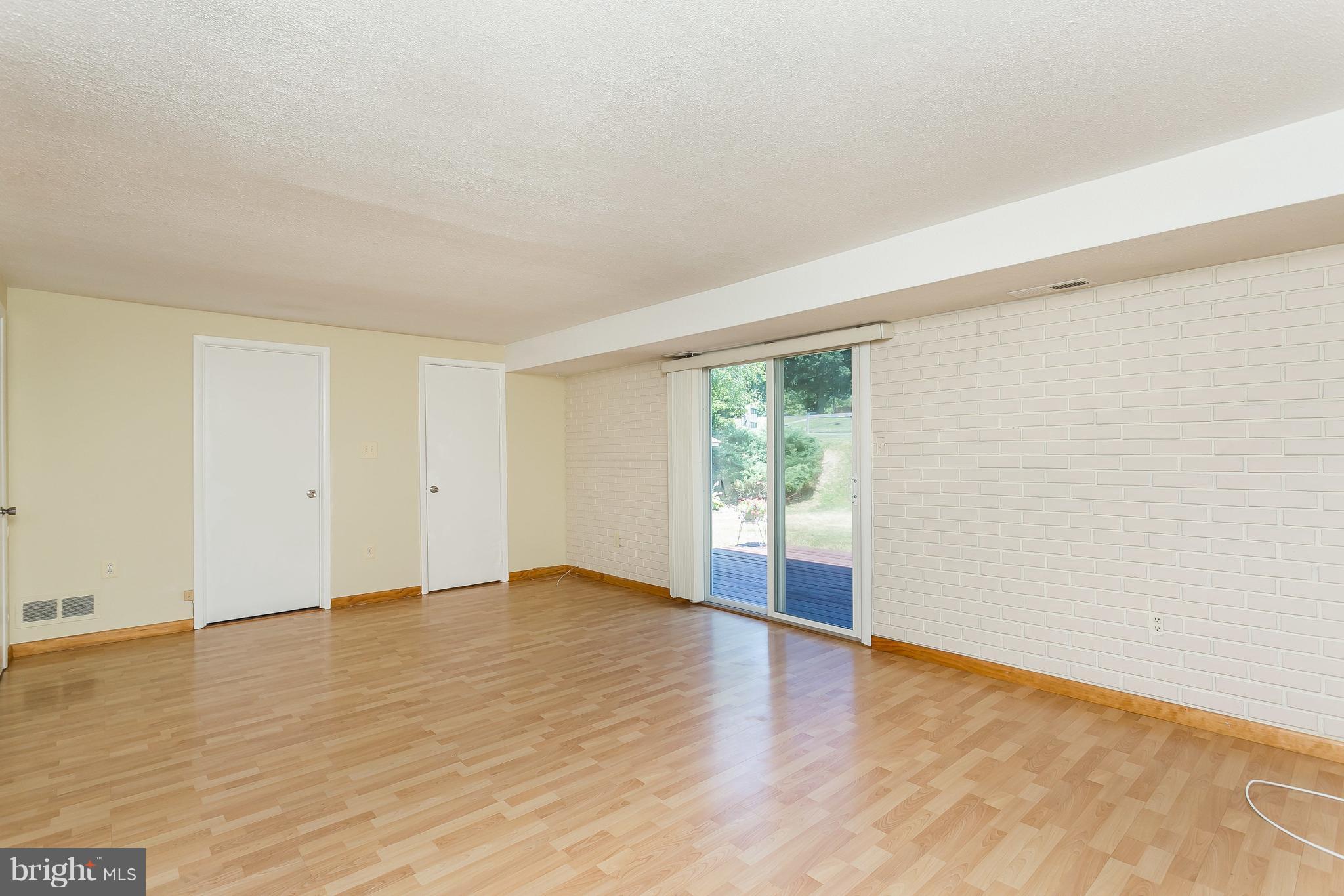 4812 Galley Road Baltimore, MD 21236 - Photo 15 of 30 a view of an empty room with wooden floor and a window